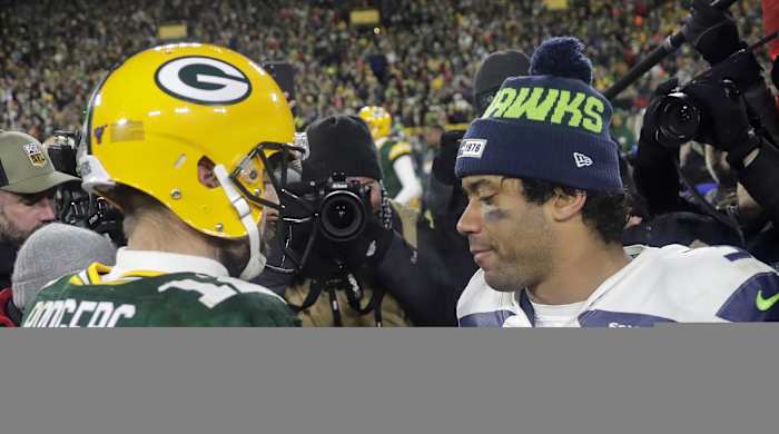 Aaron Rodgers and Russell Wilson meet at midfield.